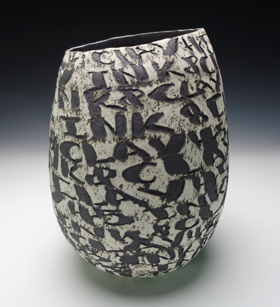 Mark Hendrickson ceramic vessel with Ink and Clay incribed horizontally on the surface