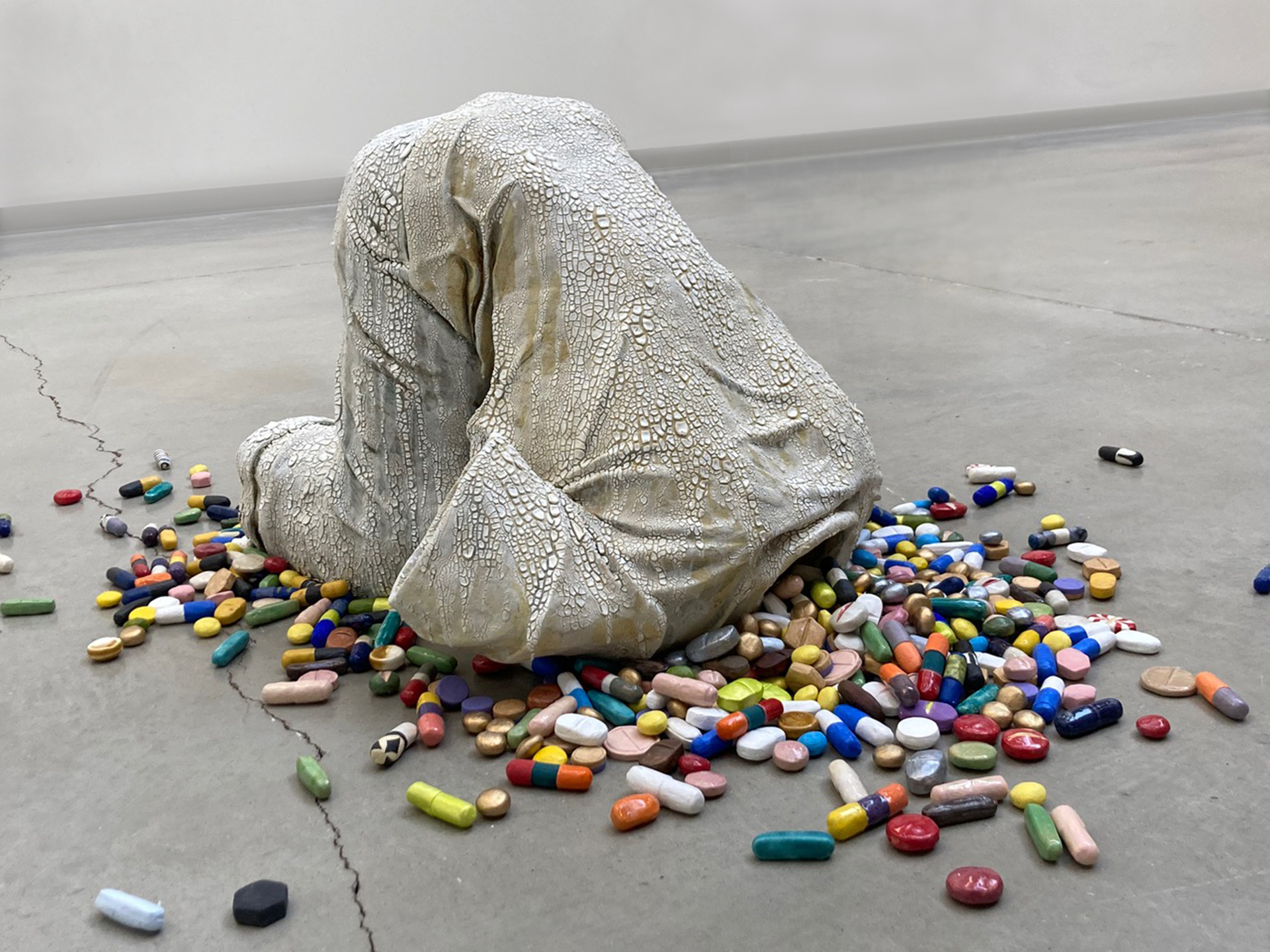 Shoko Tanaka’s project Pills is grazed ceramic sculpture of a kneeling prostate headless figure with an array of hundreds of pills flowing from the void of the torso through the neck. A powerful statement about the opioid crisis, Tanaka expands the message to include cults of personality or negative effects of digital media.