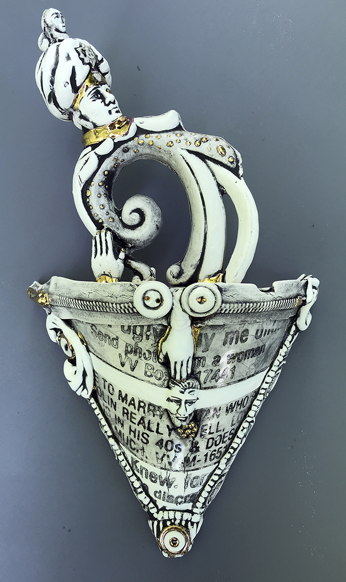 A slip cast porcelain hanging sculpture contains the cast head of a 19th century British Soldier on top of an old cast light fixture. Titled “The Old Ways are the Best,” the artist describes the piece as a “commentary on the passage of time.”